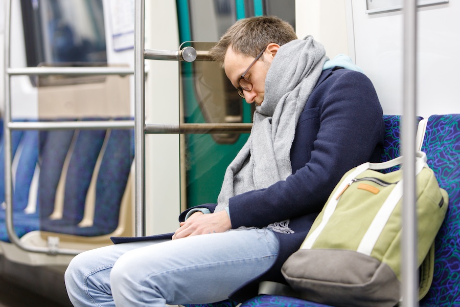 exhausted-man-sleeping-in-subway-train-after-work